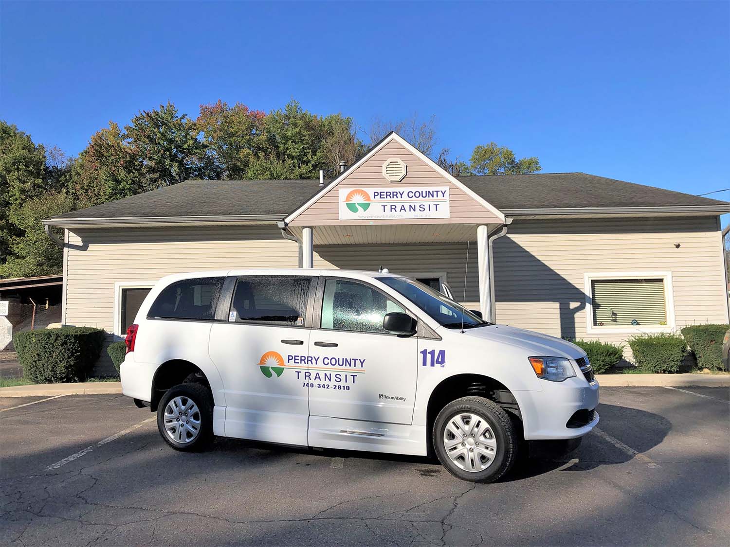 A white Perry County Transit bus parked outside the New Lexington office.